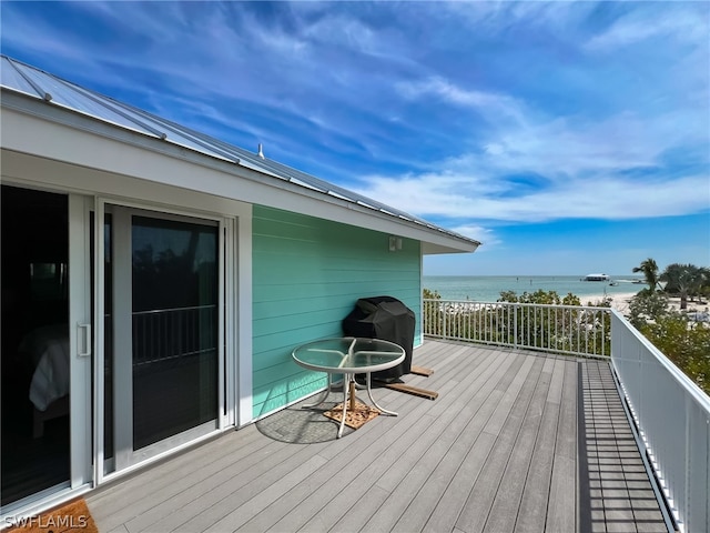 wooden deck featuring a water view