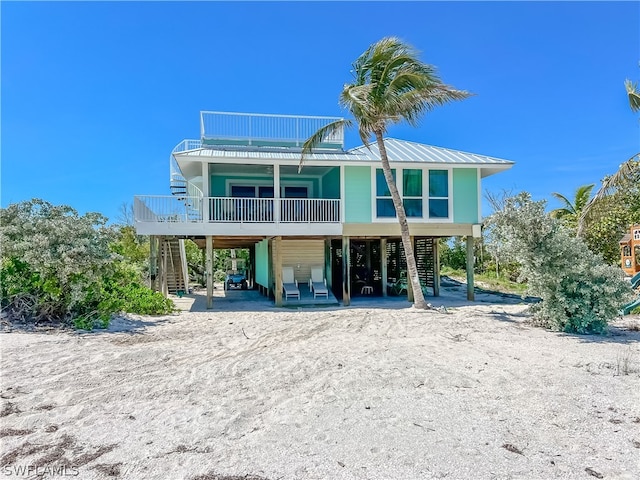 back of property with a balcony, a patio, and a deck