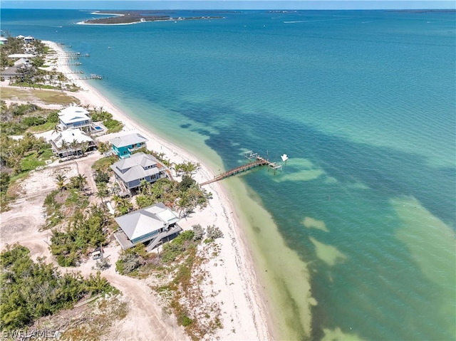 birds eye view of property featuring a beach view and a water view