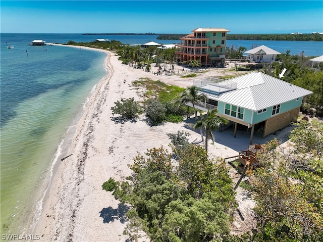 bird's eye view with a water view and a beach view