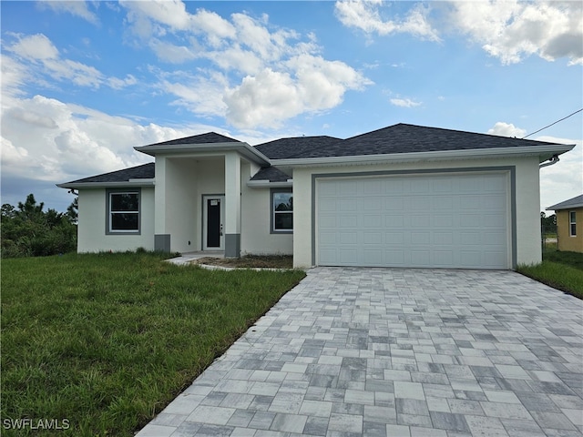 prairie-style house with a garage and a front lawn