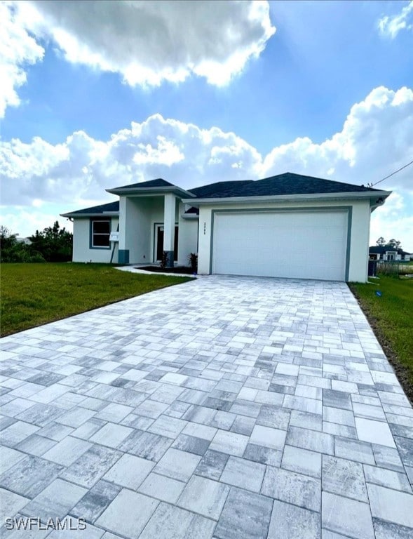 view of front of property featuring a garage and a front lawn