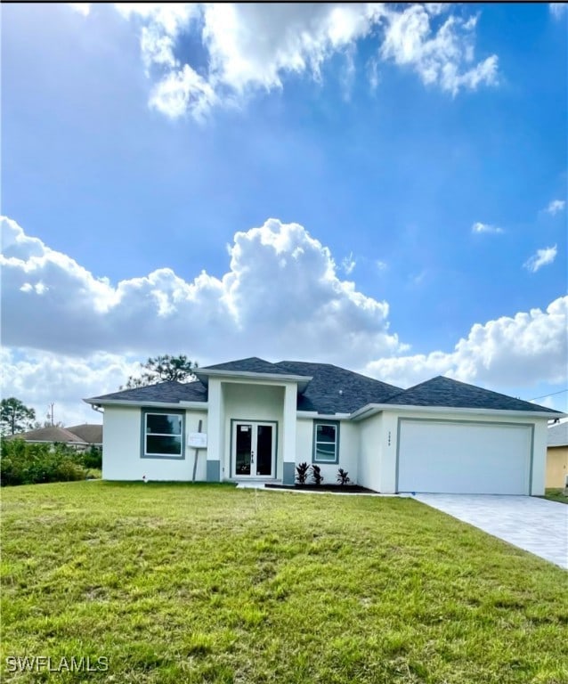 view of front facade featuring a front lawn, a garage, and french doors