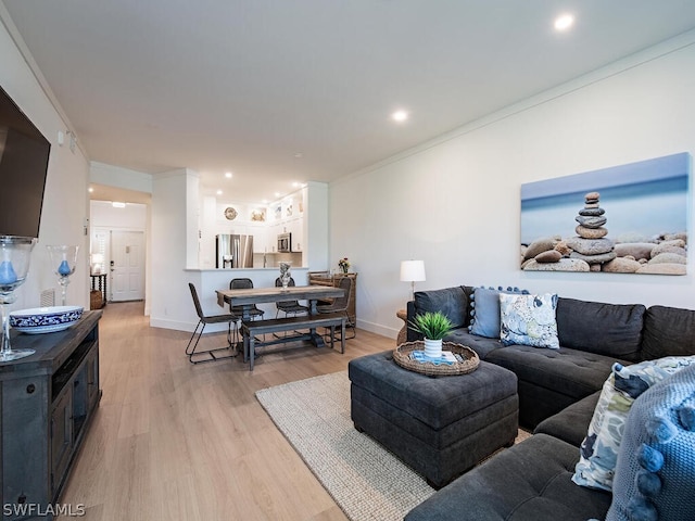 living room featuring light hardwood / wood-style floors and ornamental molding