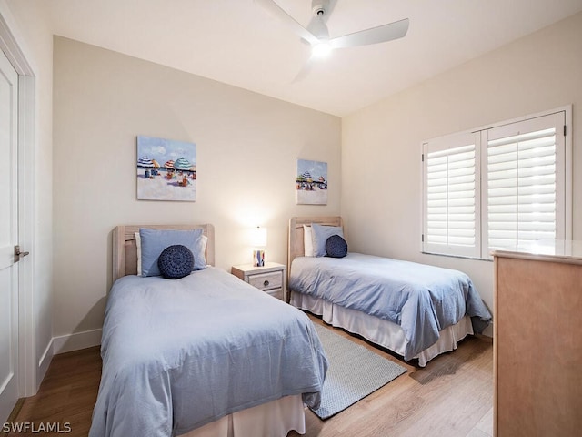 bedroom with light hardwood / wood-style floors and ceiling fan