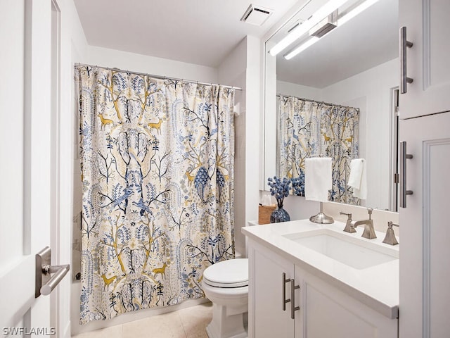 bathroom with tile patterned floors, vanity, curtained shower, and toilet