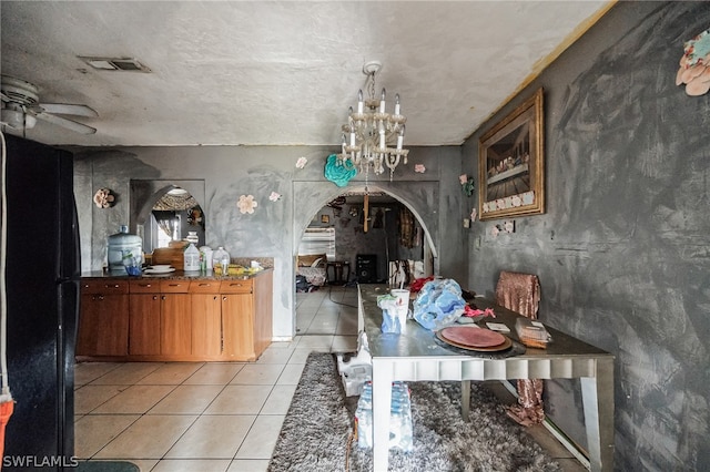 interior space with a textured ceiling and ceiling fan with notable chandelier