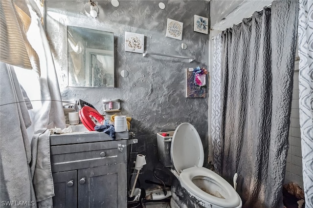 bathroom featuring toilet and vanity