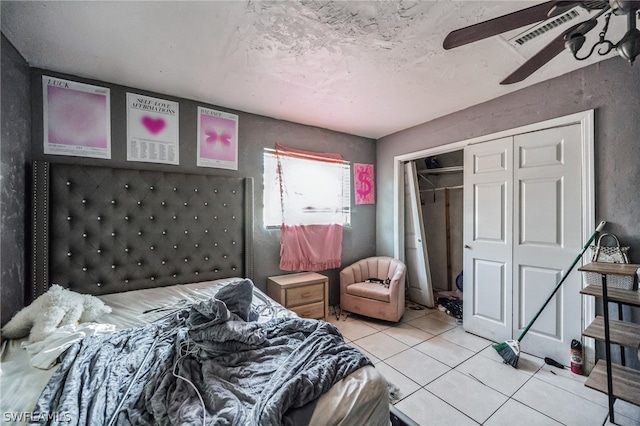 tiled bedroom featuring a closet and ceiling fan