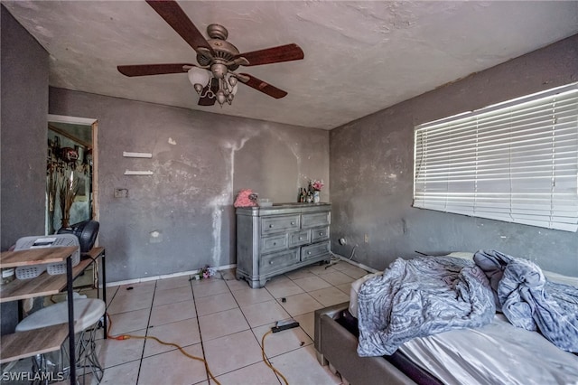 bedroom featuring light tile flooring and ceiling fan