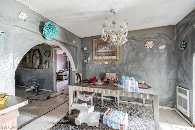 tiled dining area with an inviting chandelier