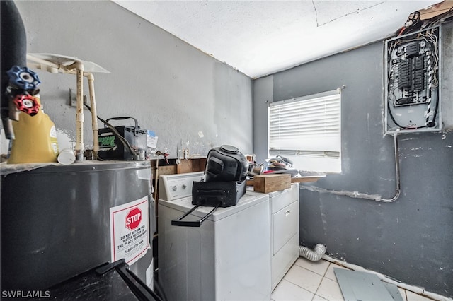 interior space with washer and clothes dryer, water heater, and light tile flooring