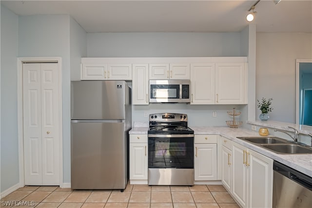 kitchen with white cabinets, appliances with stainless steel finishes, and sink