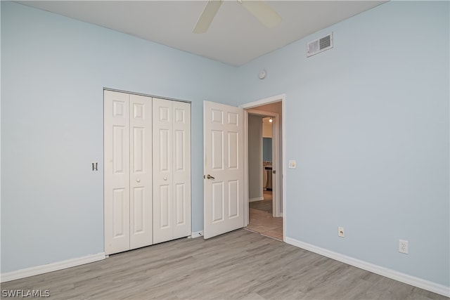 unfurnished bedroom featuring a closet, ceiling fan, and light hardwood / wood-style flooring