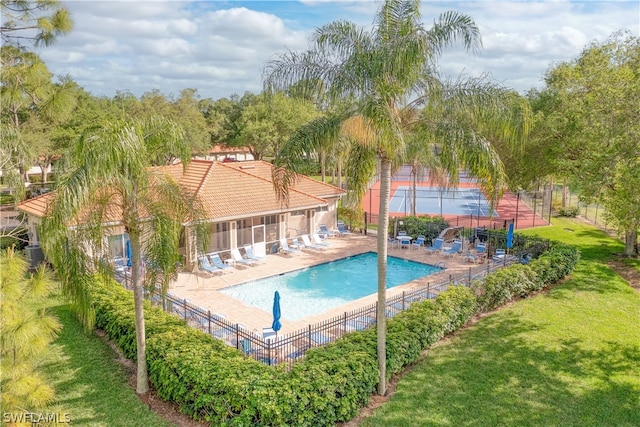 view of swimming pool with a lawn and a patio