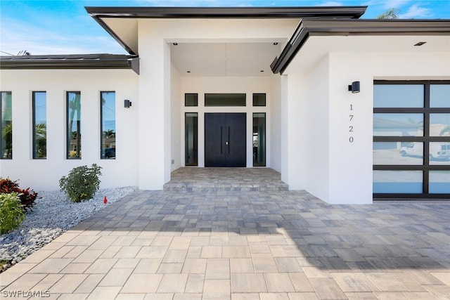 entrance to property with french doors and a patio area