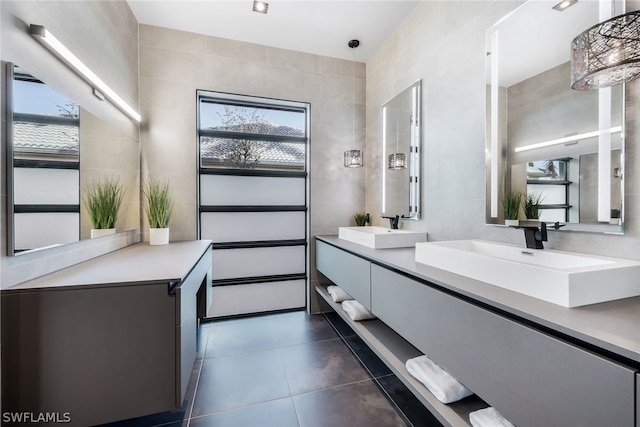 bathroom featuring tile walls, double sink vanity, and tile flooring