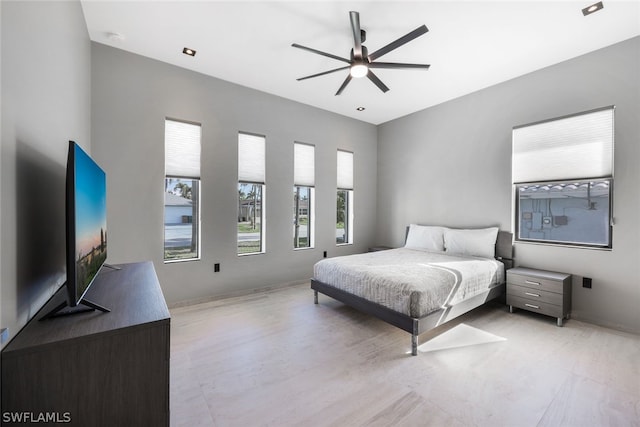 bedroom featuring multiple windows and ceiling fan