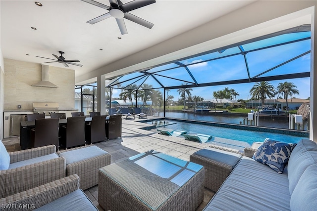 exterior space featuring a water view, light tile floors, and ceiling fan