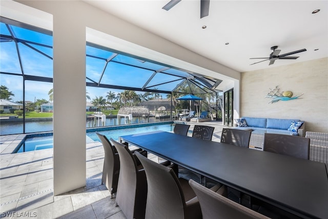 exterior space featuring light tile floors, ceiling fan, a wealth of natural light, and a water view