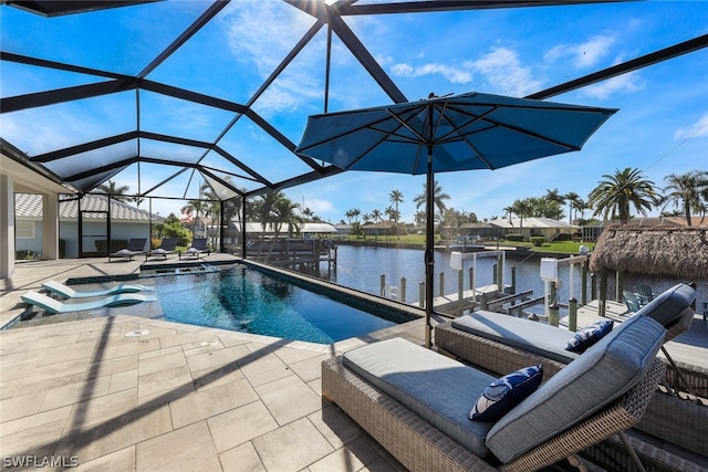 view of pool featuring a patio area, a water view, and a lanai