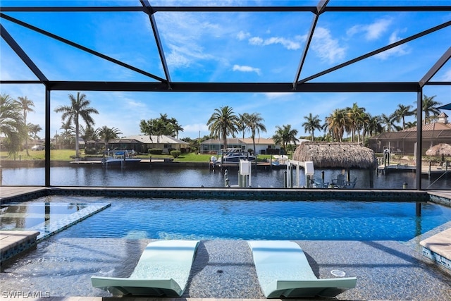 view of swimming pool with a water view and a lanai