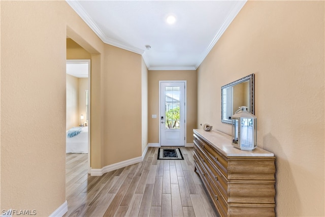 entrance foyer with light hardwood / wood-style floors and ornamental molding