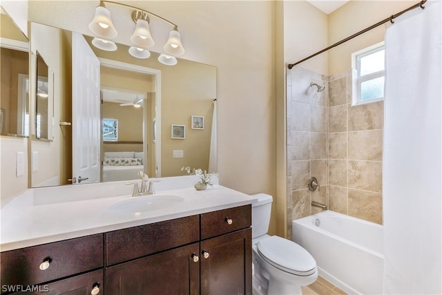 full bathroom featuring toilet, ceiling fan, shower / bath combo with shower curtain, and large vanity