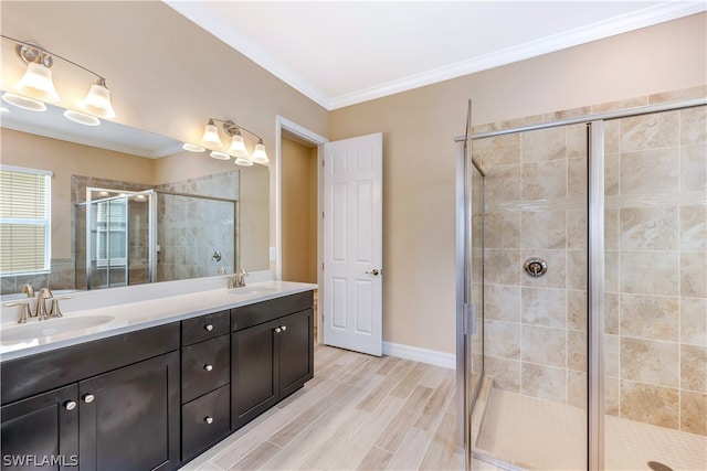 bathroom featuring vanity with extensive cabinet space, double sink, and an enclosed shower