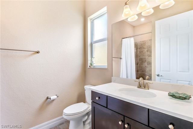 bathroom featuring tile floors, vanity, and toilet