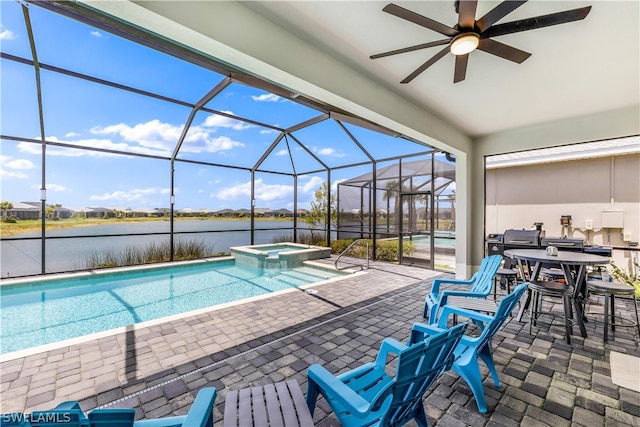 view of pool with glass enclosure, a patio area, ceiling fan, and a water view