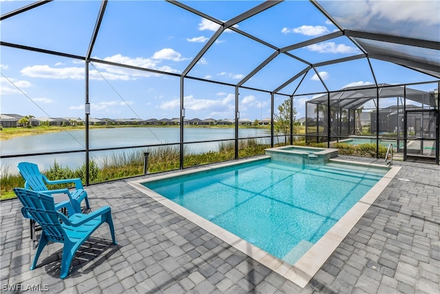 view of swimming pool with a patio area, a water view, an in ground hot tub, and a lanai