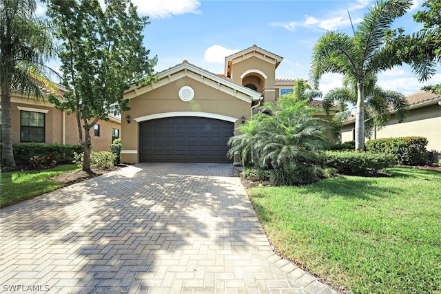 mediterranean / spanish-style home with a front yard and a garage