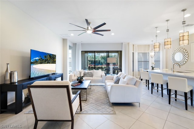 tiled living room with ceiling fan