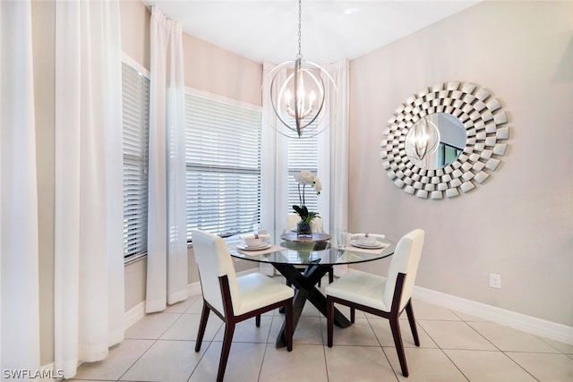 tiled dining room with a chandelier