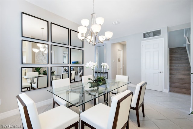 tiled dining room with a notable chandelier