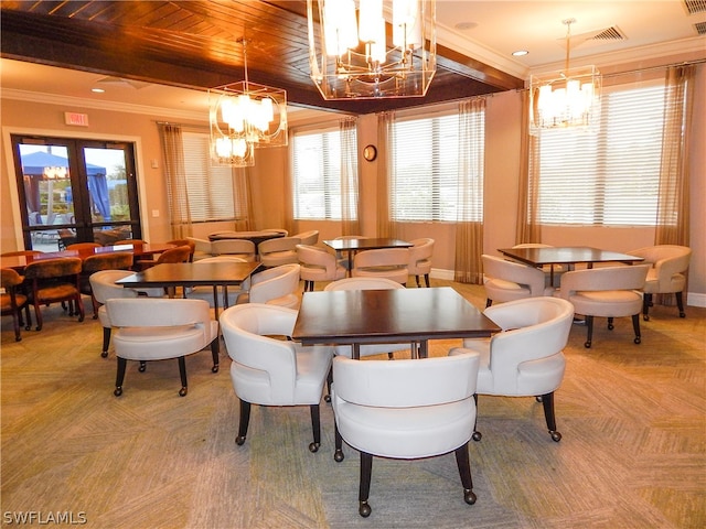 dining space featuring ornamental molding, a notable chandelier, and light parquet floors