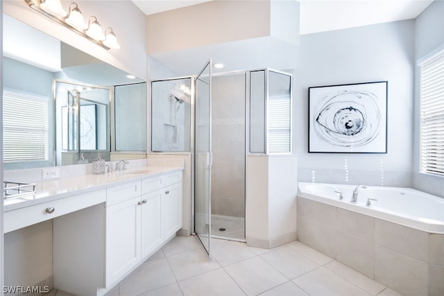 bathroom with tile floors, shower with separate bathtub, and large vanity