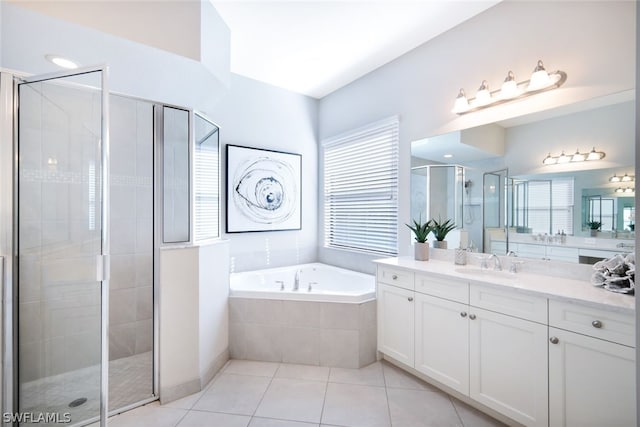 bathroom featuring tile flooring, vanity, shower with separate bathtub, and a healthy amount of sunlight