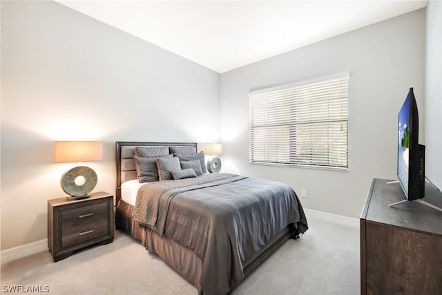 bedroom featuring light colored carpet