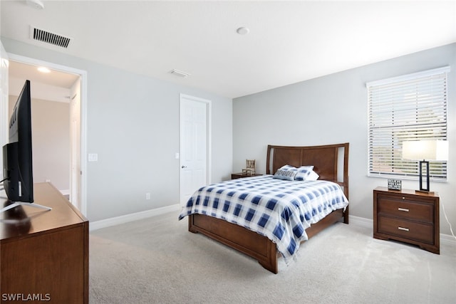 bedroom with light colored carpet