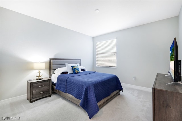 bedroom featuring light colored carpet