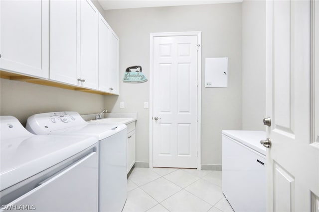 laundry area with cabinets, separate washer and dryer, sink, and light tile flooring