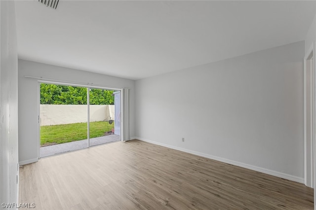 empty room with hardwood / wood-style flooring