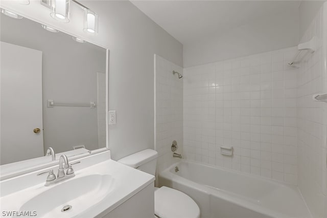 full bathroom featuring toilet, vanity, and tiled shower / bath