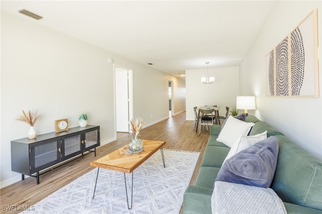 living room featuring a chandelier and hardwood / wood-style floors