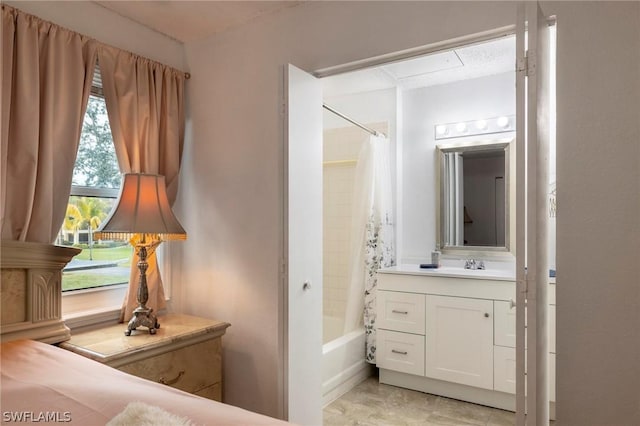 bathroom with a wealth of natural light, shower / tub combo with curtain, and vanity