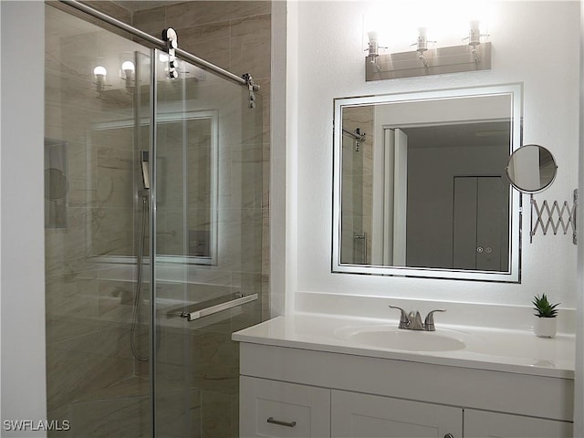 full bathroom with a shower stall and vanity