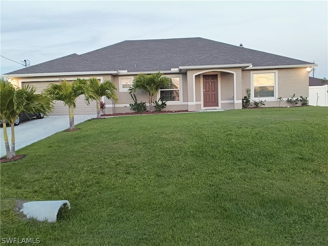 single story home featuring a front lawn and a garage