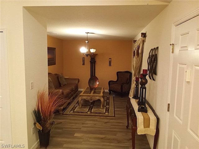 living room with a chandelier and dark hardwood / wood-style flooring